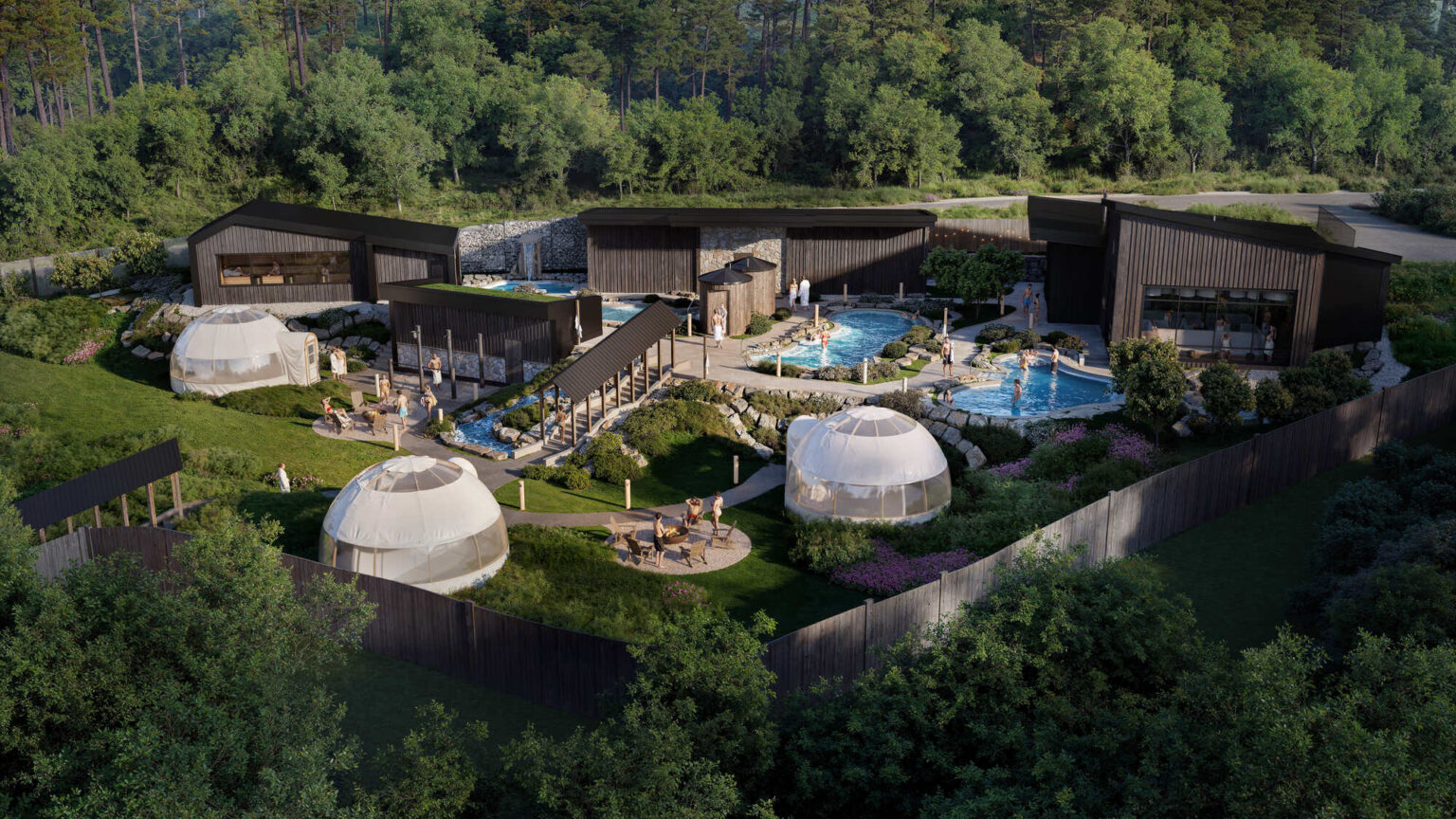 Aerial view of a modern spa resort with geodesic domes and outdoor pools