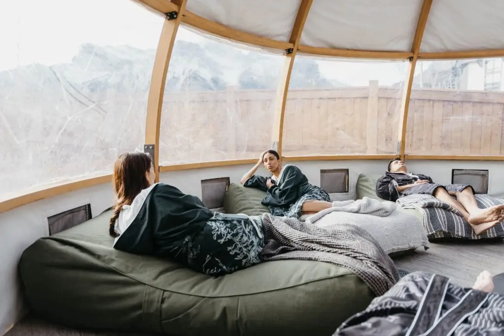 People relaxing in a geodesic dome retreat