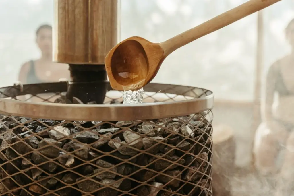 Löyly ritual: Water poured on hot sauna stones for steam.