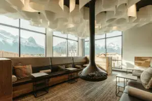 Modern lounge with mountain views, fireplace, and plush seating