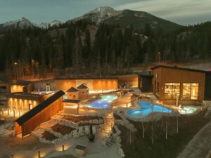 Mountain spa resort with outdoor pools and hot tubs at dusk