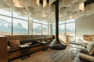 Cozy mountain lodge dining area with fireplace and scenic views