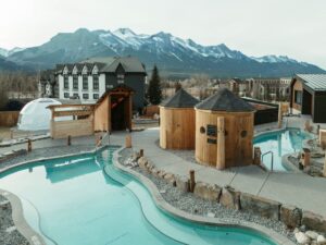Everwild mountain resort pools and saunas with snowy peaks behind