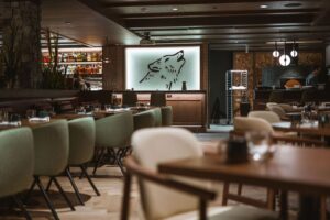 Interior of a modern restaurant in Canmore with a wolf logo