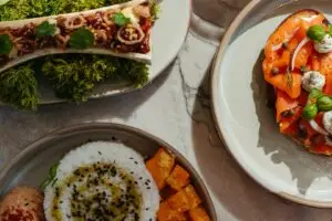 Gourmet bone marrow dish, smoked salmon toast, and rice bowl with roasted squash.
