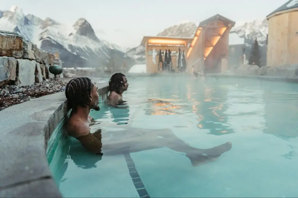 People relaxing in a hot spring, embracing Nordic wellness traditions for mental health.