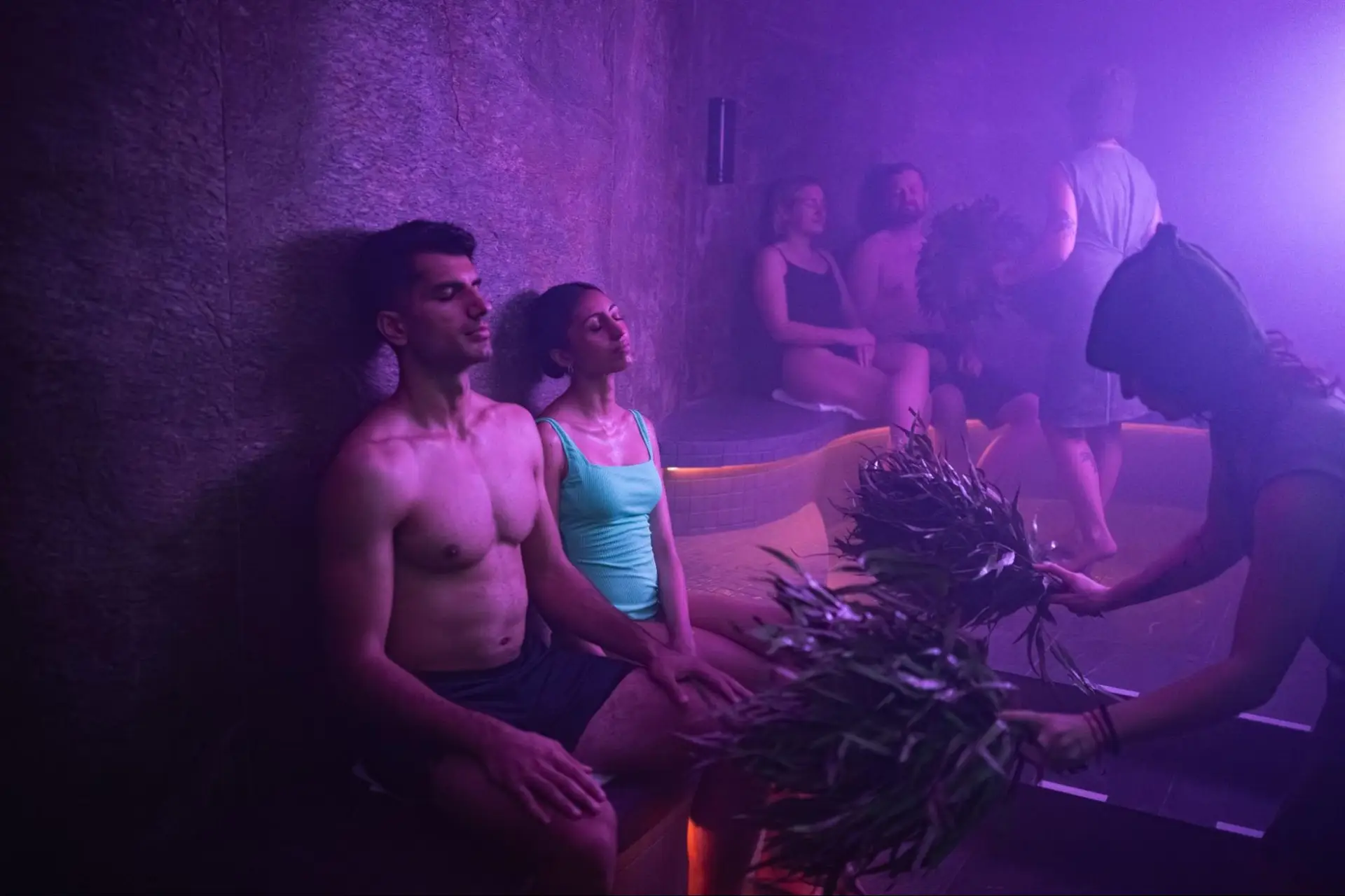 Couple relaxing in a steamy Everwild Canmore spa, exploring spa prices.